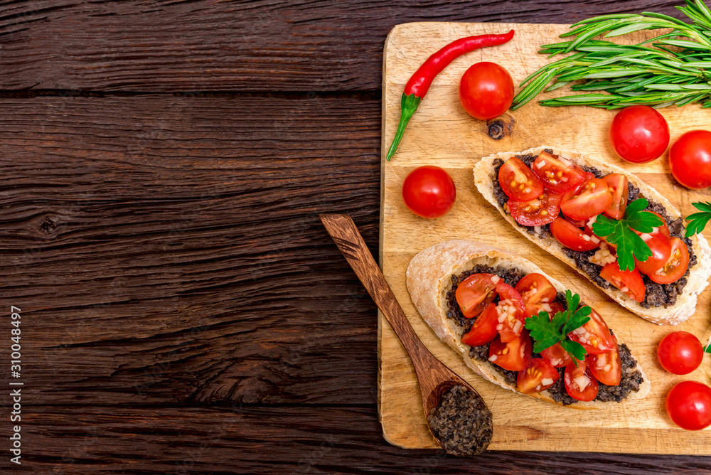 Fresh tasty bruschetta with truffle sauce, chili, parsley and tomates. Top view Fresh tasty bruschetta with truffle sauce, chili, parsley and tomates. Top view