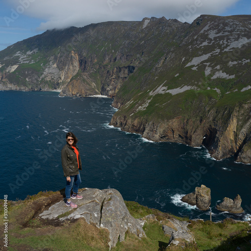 Woman at the edge of Bunglass Point, County Donegal, Ireland