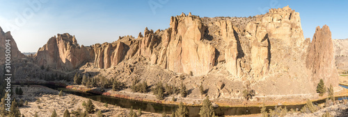 Panoramic sunset view of the Smith Rock stone walls and the Crooked River