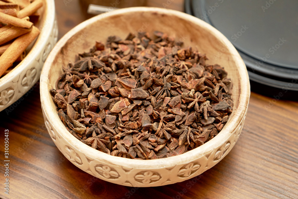 Anise stars in ceramic bowl, close-up. Dry anise stars Anise stars in ceramic bowl, close-up. Dry anise stars