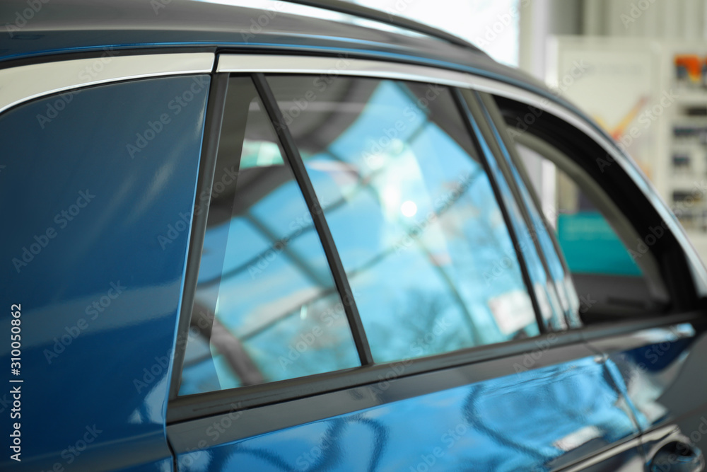 Obraz premium Modern car with tinting foil on window, closeup
