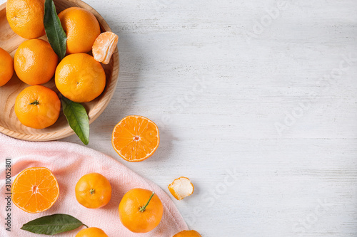 Fresh ripe tangerines on white wooden table, flat lay. Space for text