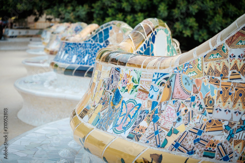 Details of a colorful ceramic bench at Parc Guell designed by Antoni Gaudi, Barcelona, Spain. photo