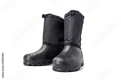 Black high insulated specialized boots for hunting off-road fishing and traveling in the cold season on a white background isolate close-up