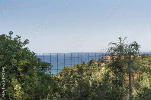 view from the mountain to the sea through the bars