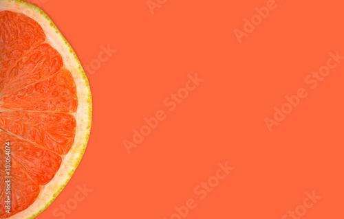 Fresh grapefruit on orange background top view banner with copy space