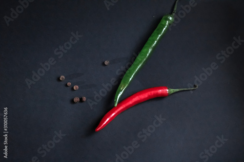 red and green chili peppers on a dark background.