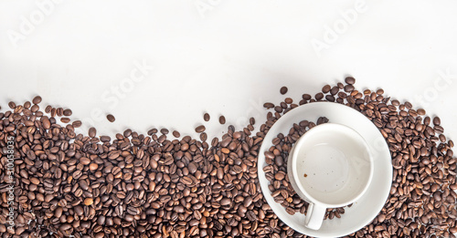 Fototapeta Naklejka Na Ścianę i Meble -  Close up photo of coffee beans and cup top view with copy space