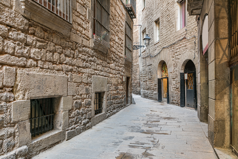 Empty street in Barcelona within the Gothic quarter. Picturesque deserted alley in Spain