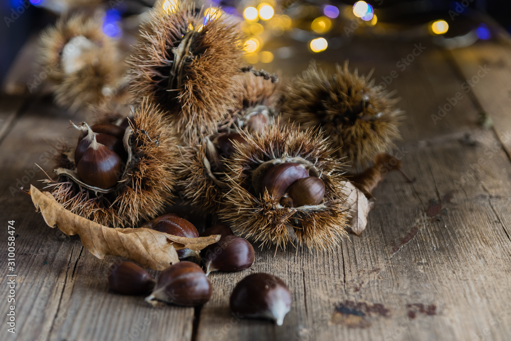 chestnuts on rustic table chestnuts on rustic table