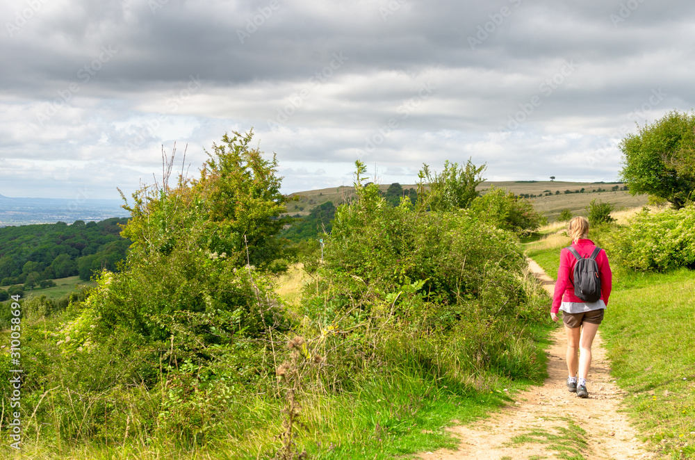Woman on a hiking trail on the Cotswold Way in central England