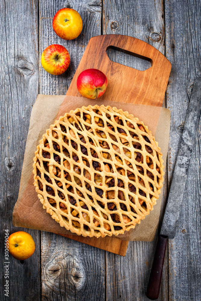 Traditional apple jalousie cake offered as top view on a modern design wooden board Traditional apple jalousie cake offered as top view on a modern design wooden board