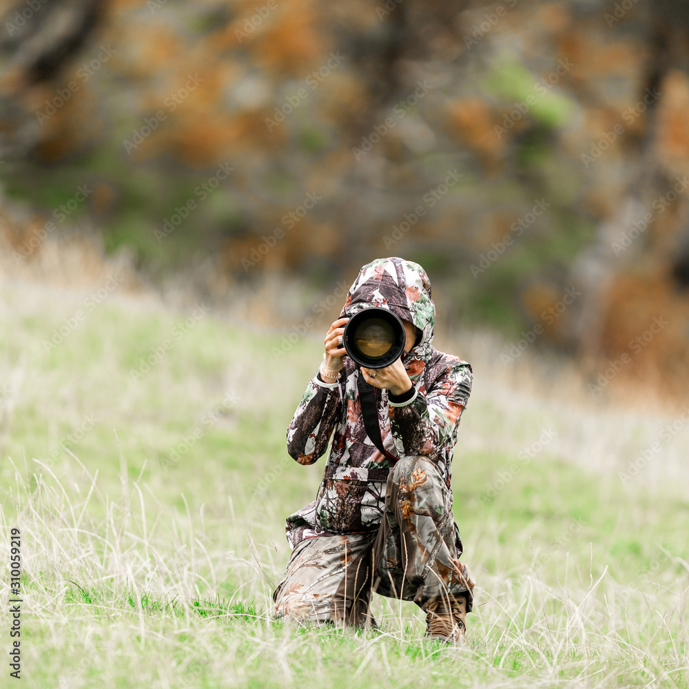 Woman wildlife photographer with big gear