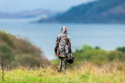 Woman wildlife photographer with big gear