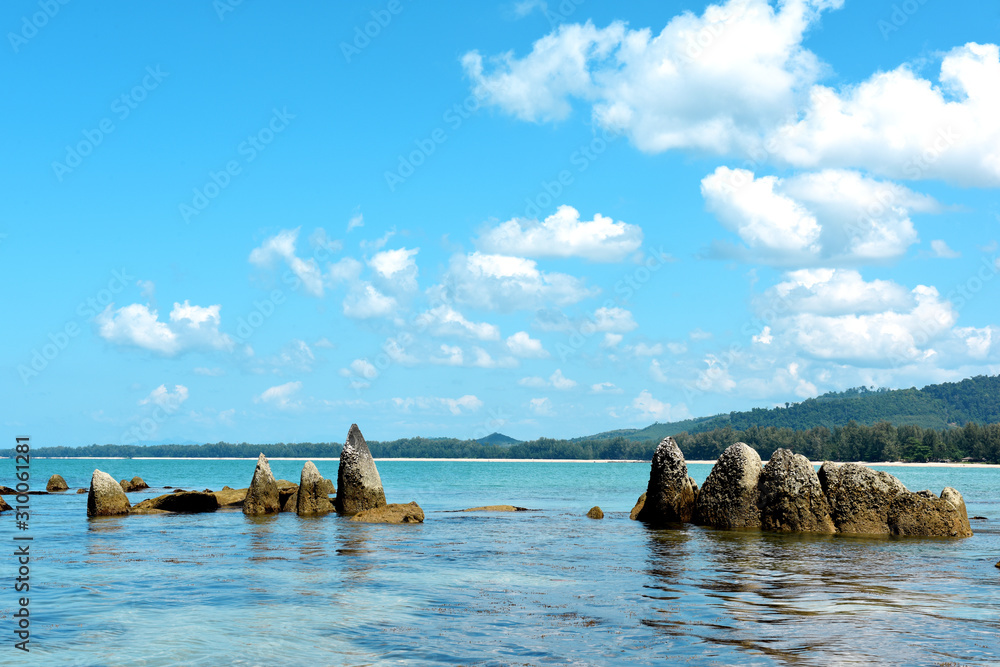 Coast of the Andaman sea at Khao Lak white sand coconut beach with palms and rocks, Thailand, Phang Nga province Coast of the Andaman sea at Khao Lak white sand coconut beach with palms and rocks, Thailand, Phang Nga province