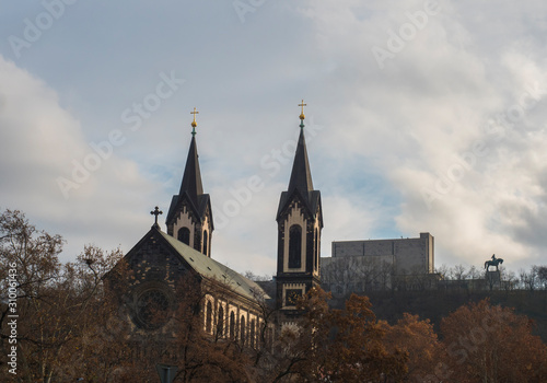 Saints Cyril and Methodius church and National Monument at Vitkov with Equestrian Statue of Jan Zizka viewed from Karlinske namesti square park with late autumn trees. Czech Republic, Prague