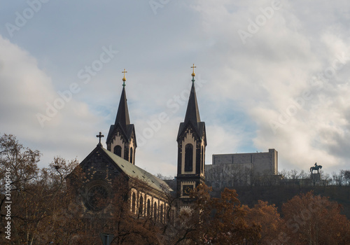 Photography Saints Cyril and Methodius church and National Monument at Vitkov with Equestrian Statue of Jan Zizka viewed from Karlinske namesti square park with late autumn trees