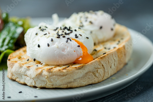 toast with poached egg on grey table