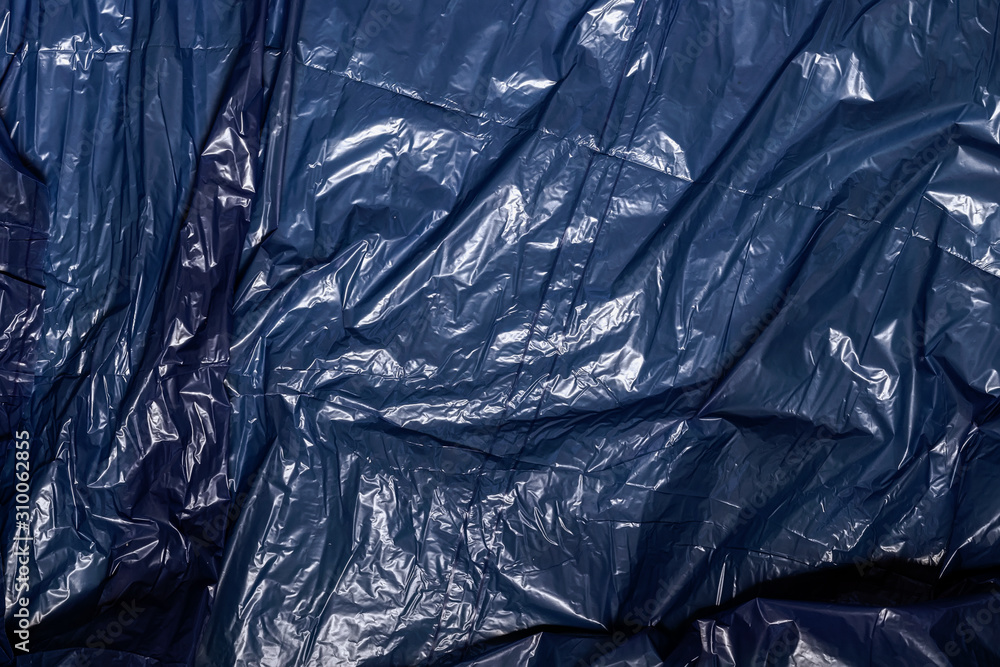 Abstract texture of black crumpled polyethylene for recycling, the concept of garbage, ecology, conservation