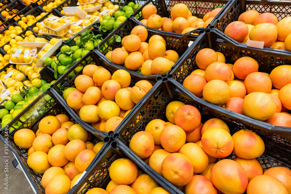 Close up various citrus fruit for sale in supermarket