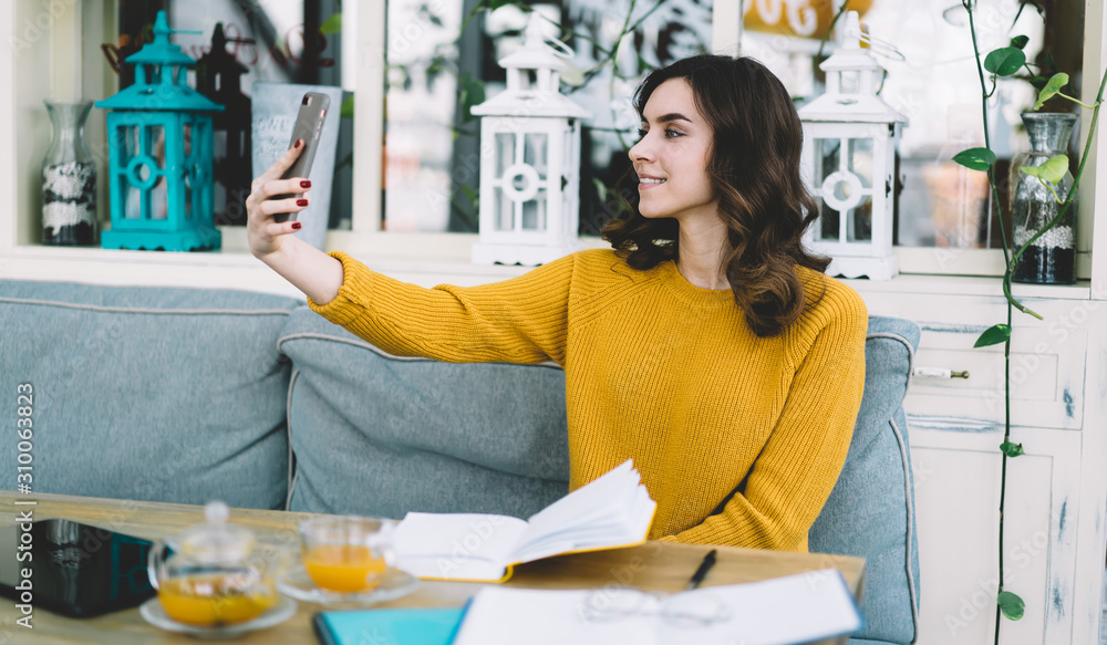 Young woman taking selfie while sitting Young woman taking selfie while sitting