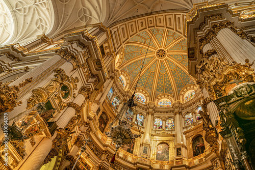 Magnificent golden dome inside the Granada Cathedral in Spain. Interior decoration found in the Granada Royal Cathedral