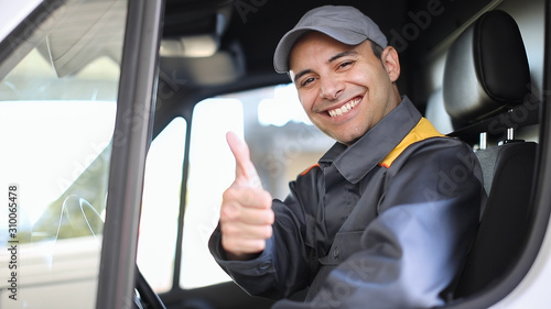 Smiling van driver portrait giving thumbs up photo