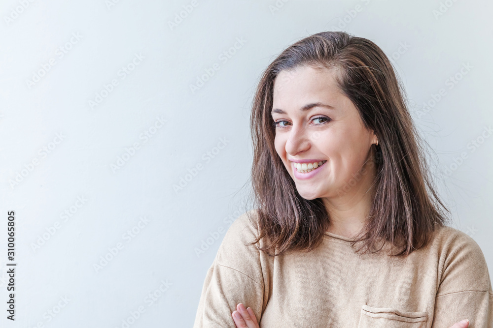 Happy girl smiling. Beauty portrait young happy positive laughing brunette woman on white background isolated. European woman. Positive human emotion facial expression body language Happy girl smiling. Beauty portrait young happy positive laughing brunette woman on white background isolated. European woman. Positive human emotion facial expression body language