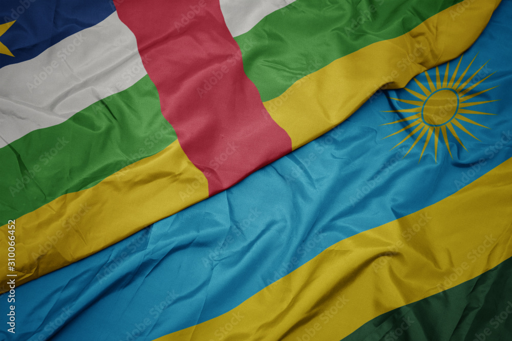 Obraz premium waving colorful flag of rwanda and national flag of central african republic.