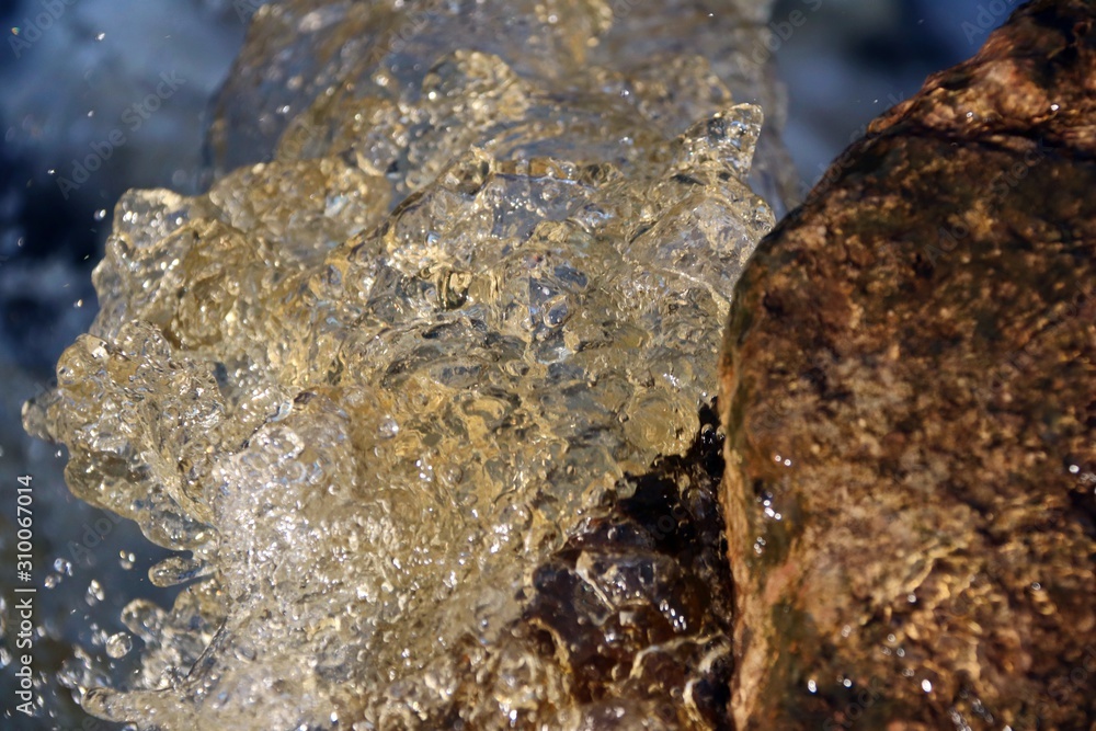 water stream cascade falling on the rocks close up