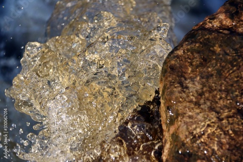 water stream cascade falling on the rocks close up