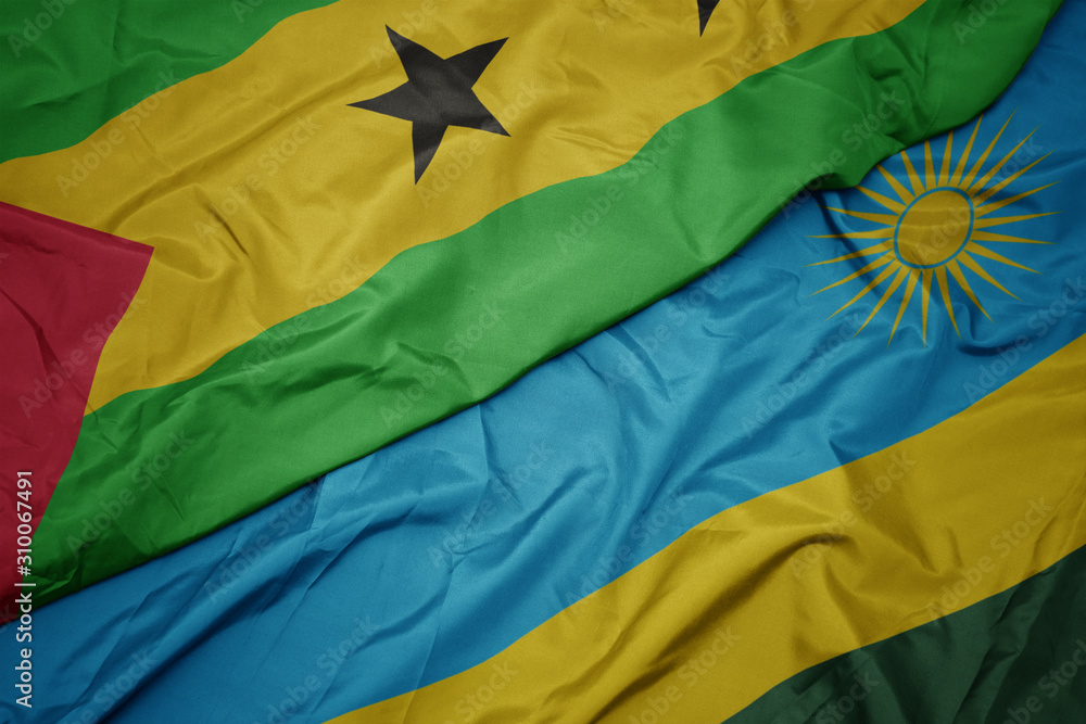 waving colorful flag of rwanda and national flag of sao tome and principe .