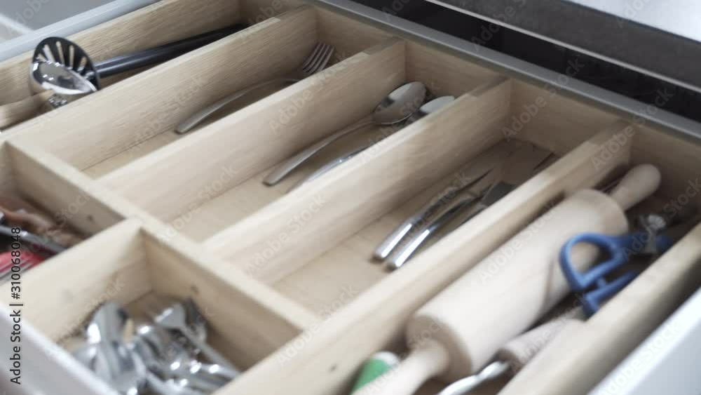 pulling the cutlery out of the cutlery drawer pulling the cutlery out of the cutlery drawer