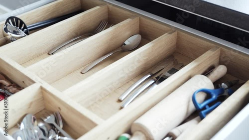 pulling the cutlery out of the cutlery drawer