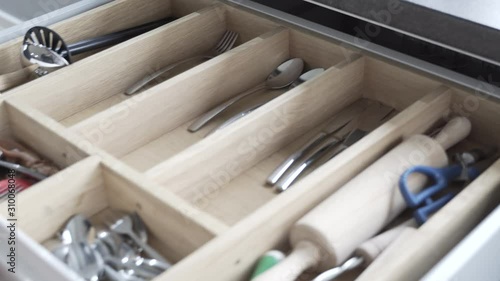 pulling the cutlery out of the cutlery drawer