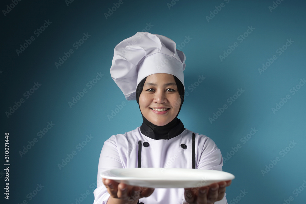 Asian Female Chef Shows Empty White Plate, Presenting Something, Copy Space Asian Female Chef Shows Empty White Plate, Presenting Something, Copy Space