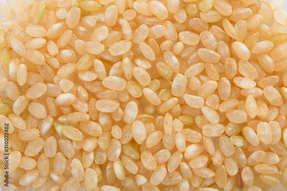 brown unpolished japanese rice. food background brown unpolished japanese rice. food background