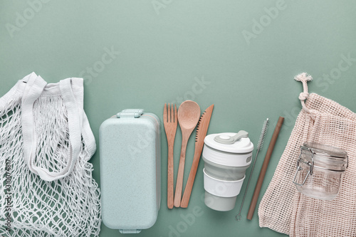 Set of reusable eco friendly products . Zero waste concept. Cotton bags, bamboo cutlery, straw, reusable cup and lunch box