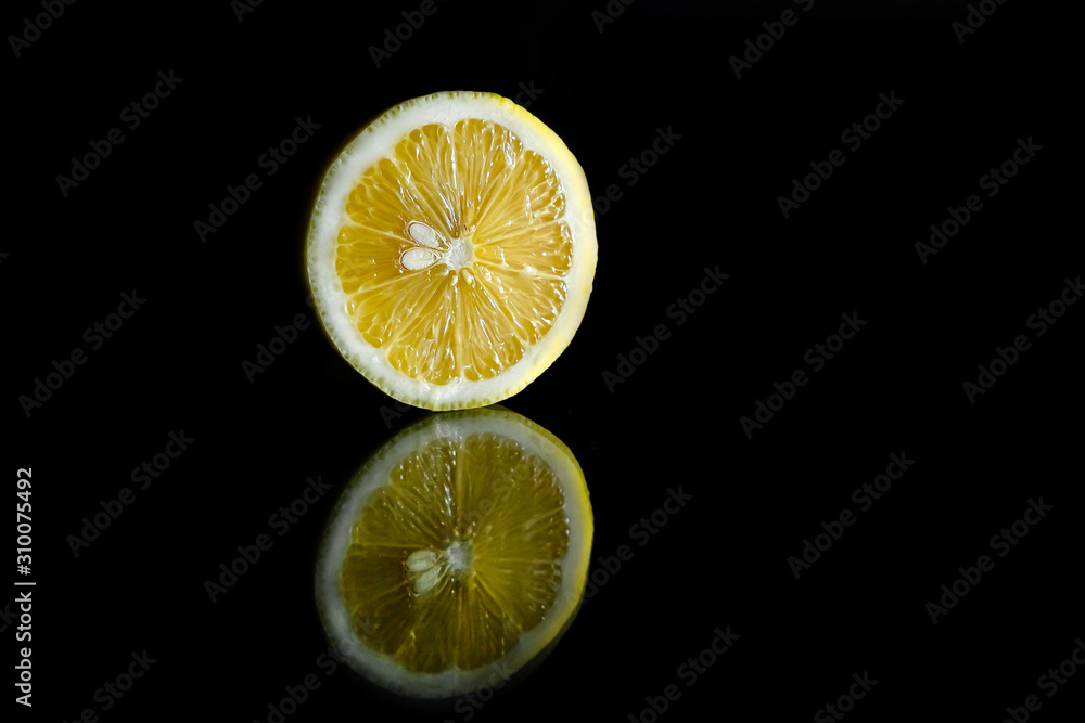 Close up view of lemon piece isolated on black. Close up view of lemon piece isolated on black.