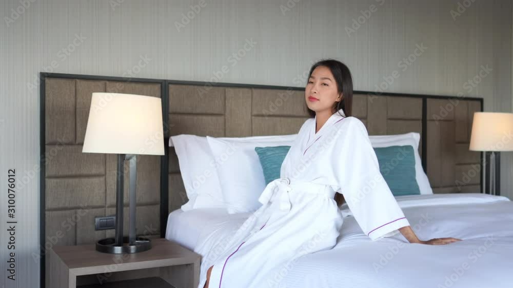 Independent asian lady in bathrobe enjoying in a luxurious hotel