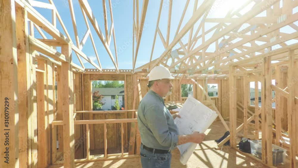 Construction worker on site with building plans