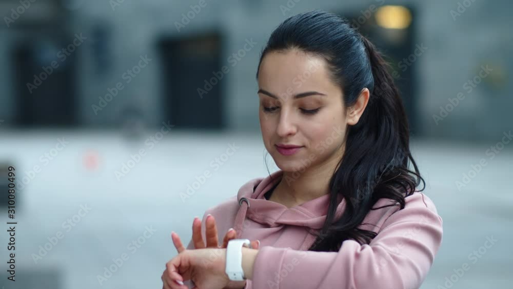 Portrait of fitness woman using smart clock. Sporty woman reading message Portrait of fitness woman using smart clock. Sporty woman reading message