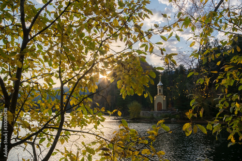 View of the Orthodox Church through the fall foliage photo