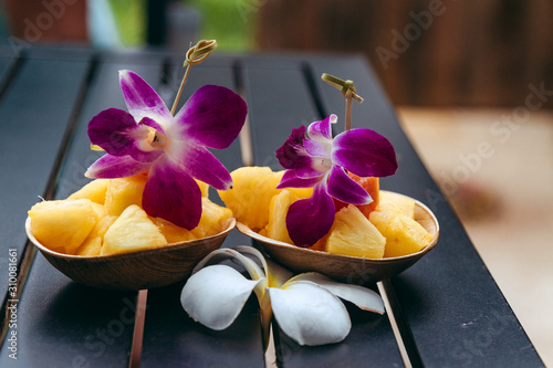 фотографія pineapple fruit bowl with edible arrangements orchids