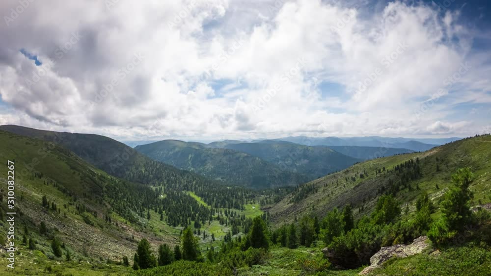 Time lapse of amazing mountain scenery. Scenic green mountain valley in sunny day and blue sky with moves clouds. Timelapse of cloudscape Time lapse of amazing mountain scenery. Scenic green mountain valley in sunny day and blue sky with moves clouds. Timelapse of cloudscape