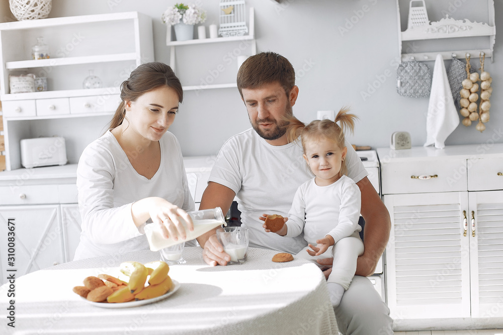 Family in a kitchen. pregnant woman. Little girl with parents. Family in a kitchen. pregnant woman. Little girl with parents.