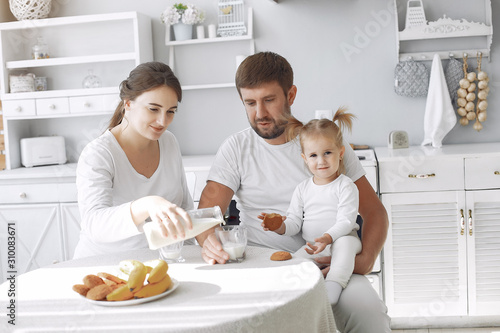 Family in a kitchen. pregnant woman. Little girl with parents.