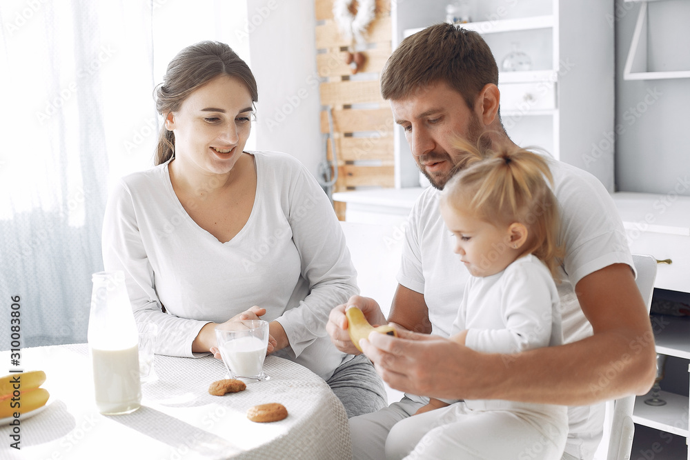 Family in a kitchen. pregnant woman. Little girl with parents. Family in a kitchen. pregnant woman. Little girl with parents.