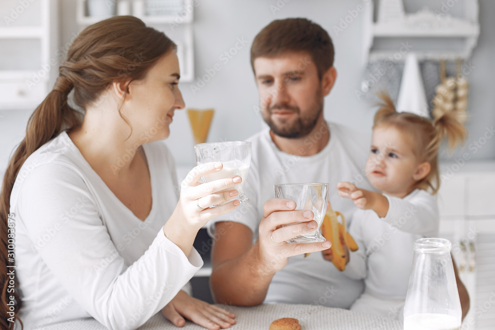 Family in a kitchen. pregnant woman. Little girl with parents. Family in a kitchen. pregnant woman. Little girl with parents.
