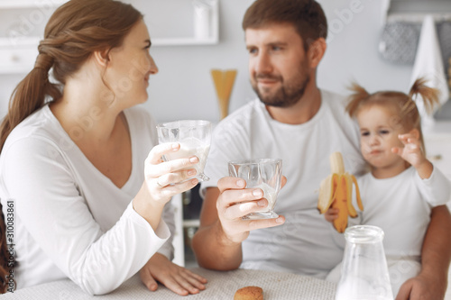 Family in a kitchen. pregnant woman. Little girl with parents.